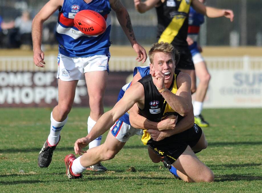 JUST IN TIME: Wagga Tigers' Nick McCormack gets a handball away as he gets tackled by his Turvey Park opponent at Robertson Oval on Saturday. Picture: Laura Hardwick