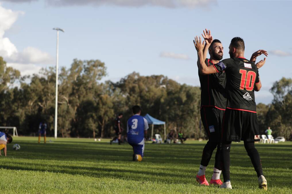 BROTHERS IN ARMS: Henri Gardner celebrates a goal with his brother Fred in Leeton United's 4-0 win over Tolland at Rawlings Park on Sunday. Picture: Madeline Begley