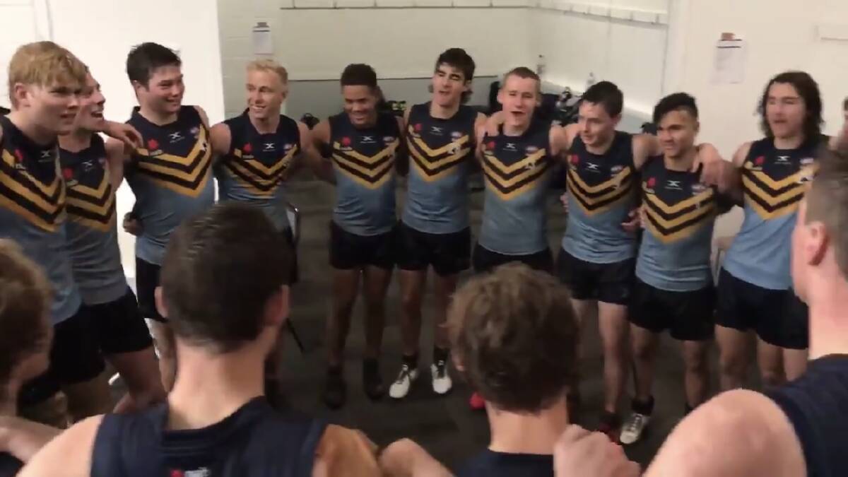 HAPPY DAYS: NSW-ACT Rams' under 17 team sing the team song after a win over Queensland on Monday.