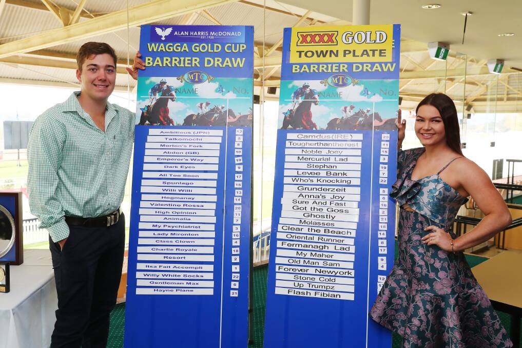 ON SHOW: Faces of the carnival Will Peterson and Hollee Bohr show off the final fields for the Gold Cup and Town Plate at Tuesday's barrier draw at Murrumbidgee Turf Club. Picture: Emma Hillier