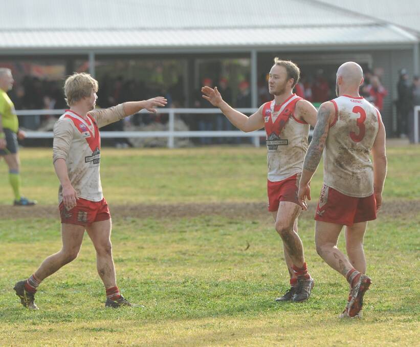 Griffith's Ben King, coach Will Griggs and Guy Orton enjoy last week's win over Collingullie-Glenfield Park.