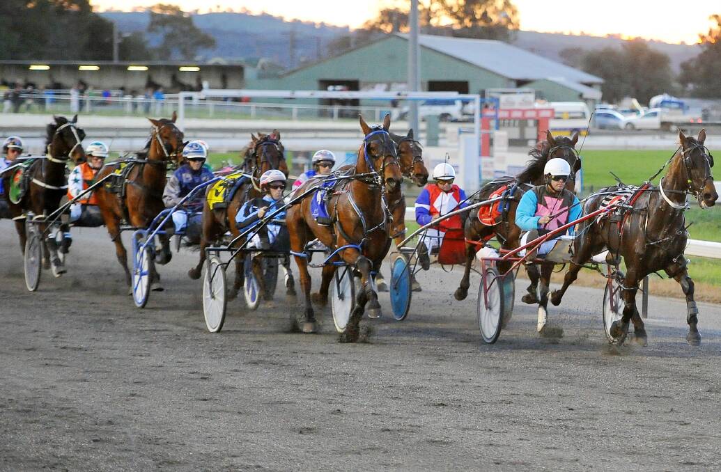 TOP RACING: Million Dollar Gem leads the field with a lap remaining in the second race at Wagga Paceway on Friday night. Pictures: Kieren L Tilly