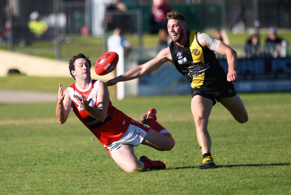 FULL STEAM: Collingullie-Glenfield Park forward Marc Geppert looks to mark despite close attention from Wagga Tigers' Louis Beard at Robertson Oval on Saturday.