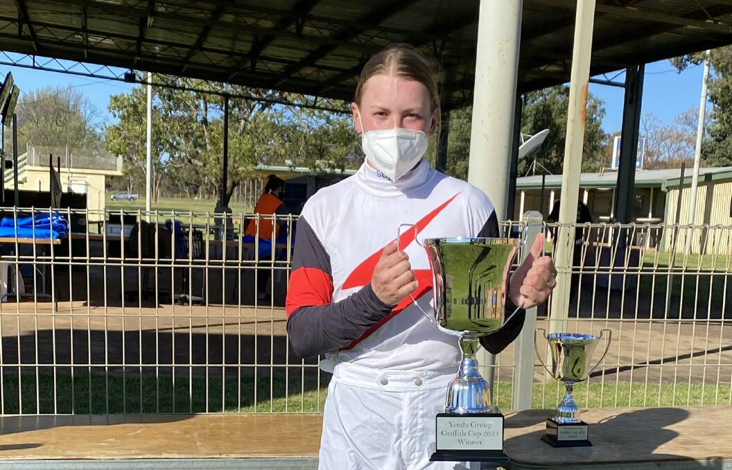 TALENT: Albury apprentice jockey Fiona Sandkuhl shows off the Griffith Cup she won aboard Claptone on Saturday. Picture: Craig Weeding Racing