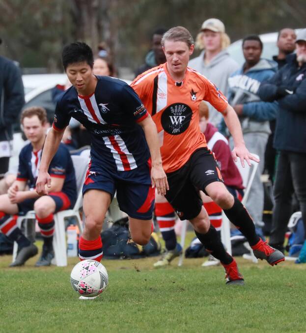 NO MORE: Spectators watch on as Henwood Park's Tam Tin Kit and Wagga United's Adrian Merrigan battle it out in the Pascoe Cup game at Rawlings Park last Sunday. Picture: Les Smith