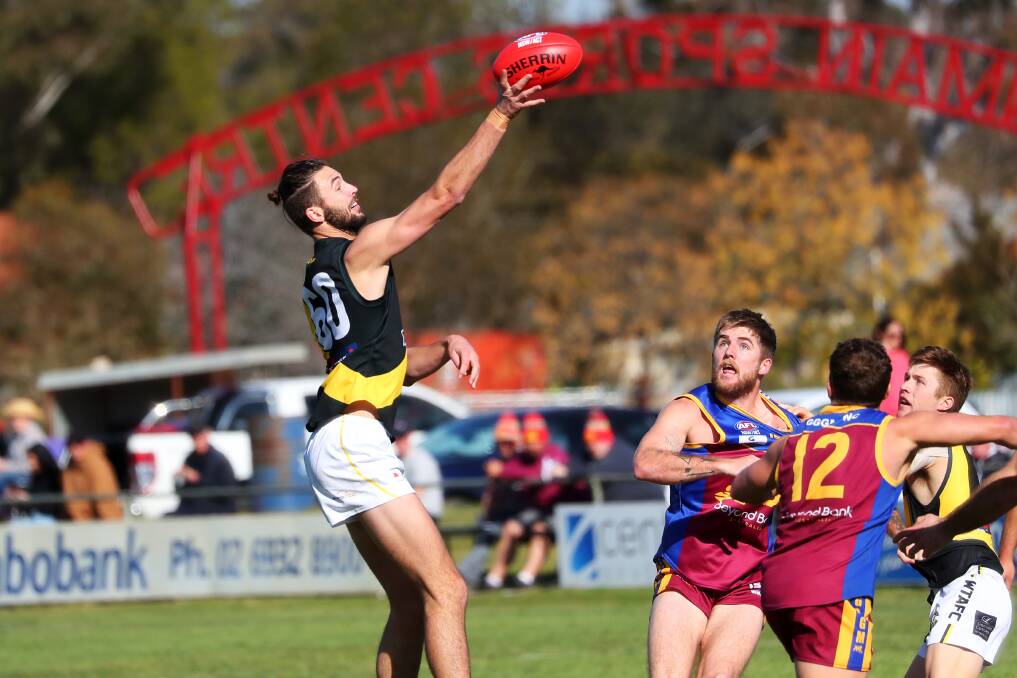 SUCCESS: Wagga Tigers ruckman Brad Graham gets his hand to the ball in the AFL Riverina Championship game against Ganmain-Grong Grong-Matong at Ganmain Sportsground earlier this month. Picture: Emma Hillier