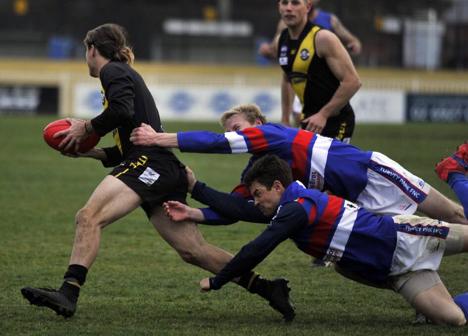 DESPERATION: Wagga Tigers' Campbell Lovell gets away from Turvey Park's Truman Carroll and Lachie McRae at Robertson Oval on Saturday. Picture: Chelsea Sutton