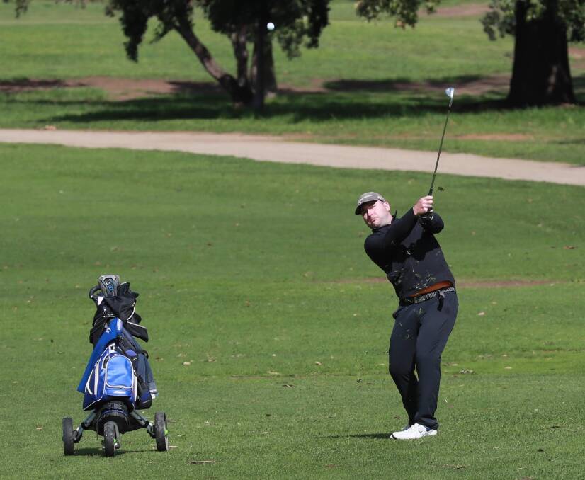 Adrian Reynolds plays his approach shot to the ninth at Wagga Country Club last month.