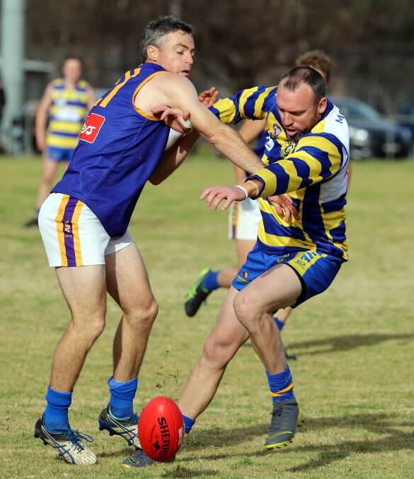 Narrandera's Stephen Irons and MCUE's Jordan Doering compete in the Riverina League game at Mangoplah Sportsground this year. Picture: Les Smith