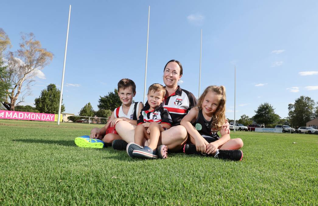 North Wagga footballer Melinda Hyland with children Teddy, eight, Andy, three, and Albie, six, at McPherson Oval on Tuesday ahead of her 350th game on Friday night. Picture by Les Smith