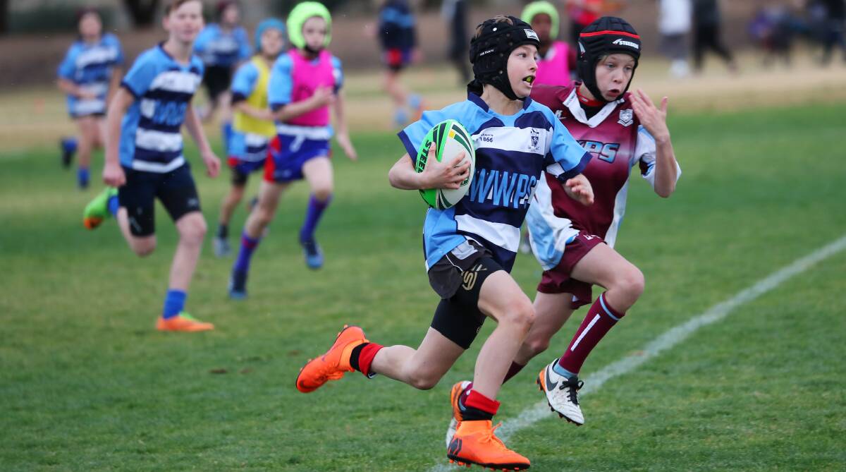 ON THE RUN: Wagga Public's Harry Austin tries to get away from Deacon Crawford at the Mortimer Shield gala day at Parramore Park on Tuesday. Picture: Emma Hillier 