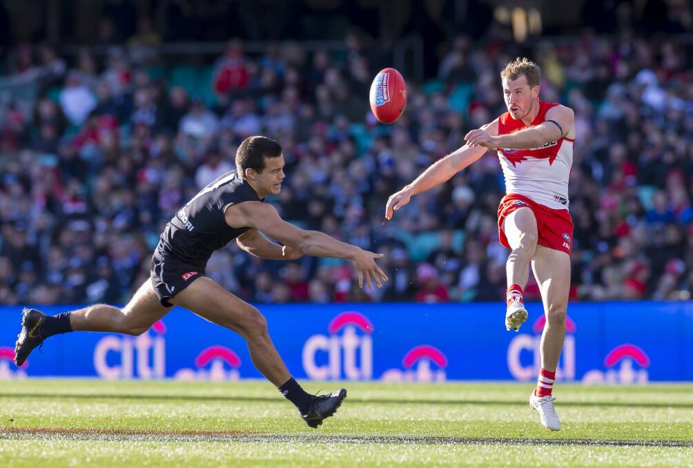 LOCKED IN: Harry Cunningham gets a kick away in the round 17 AFL game against Carlton at the SCG. Picture: AAP