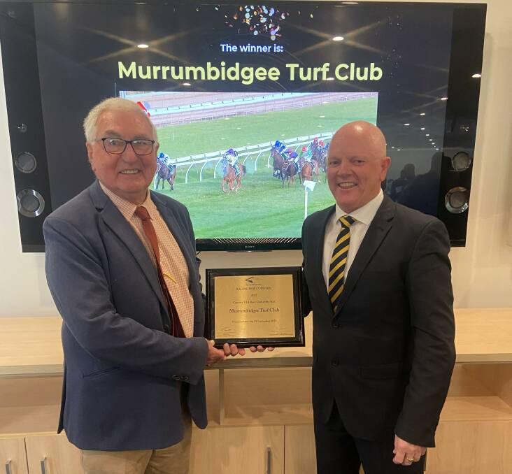 Murrumbidgee Turf Club chief executive Jason Ferrario accepts the Country TAB Race Club of the Year award from NSW Country Racing chairman Bob Pavitt. Picture supplied