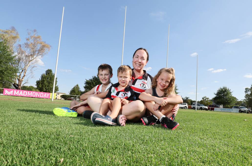 North Wagga footballer Melinda Hyland with children Teddy, eight, Andy, three, and Albie, six, at McPherson Oval on Tuesday ahead of her milestone appearance. Picture by Les Smith