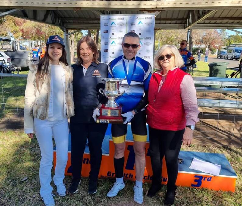 SPECIAL MOMENT: Griffith cyclist Steve Bertaldo with the Dean Carter Memorial trophy, and the Jake Carter Medal, with members of the Carter family in Griffith on Sunday. Picture: Griffith Cycle Club