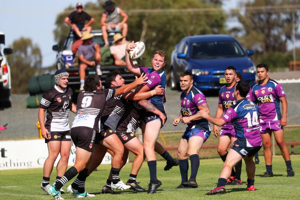 DRIVEN: Southcity's Tim Hurst looks to get an offload away after being met solidly by the Yass Magpies defence at the West Wyalong Knockout earlier this year. Picture: Emma Hillier