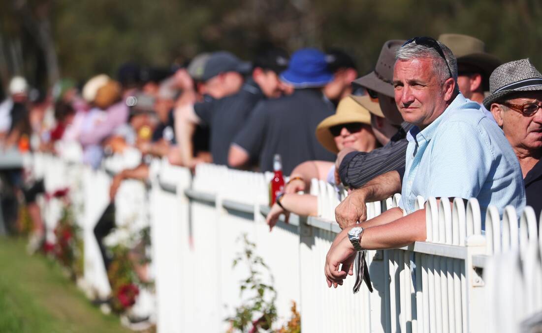 Punters line the fence at Gundagai for the Snake Gully Cup (1400m). Picture: Emma Hillier