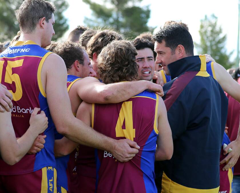 GGGM coach Christin Macri talks to his players at quarter time on Sunday. Picture: Les Smith
