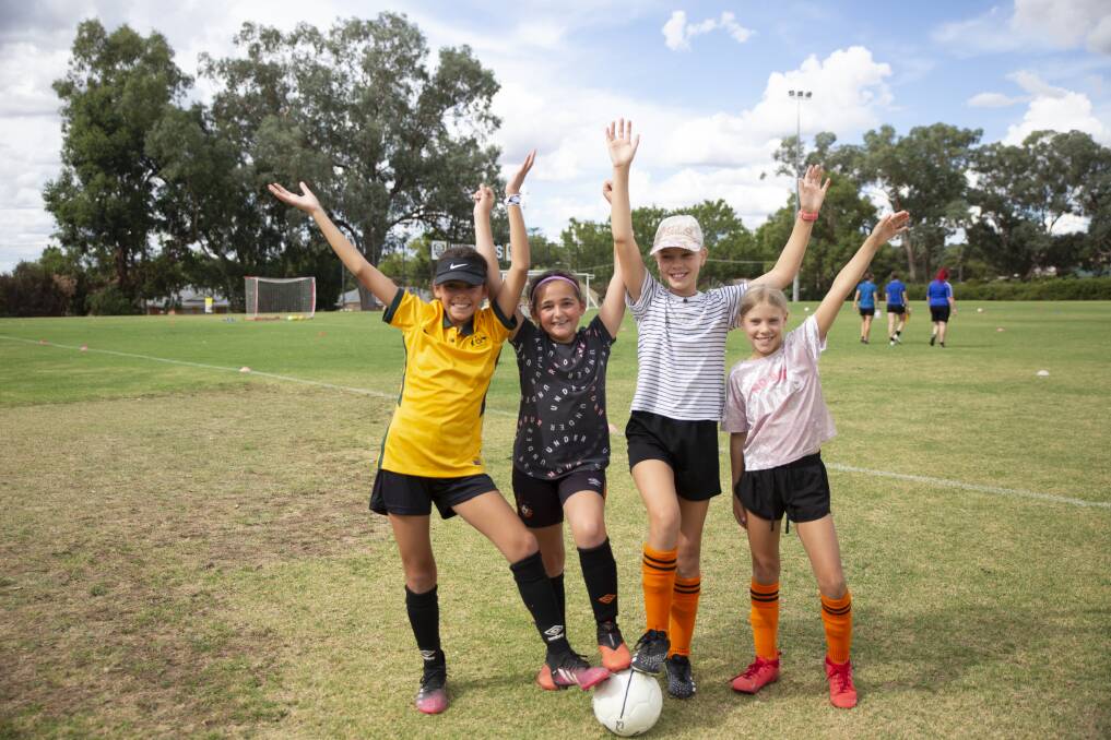 HAVING A BALL: Sisters Tasha, 12, and Eddi Pizarro, 11, alongside sisters Freja, 11, and Tilda Robertson, eight, at the Female Festival of Football at Gissing Oval on Sunday. Picture: Madeline Begley