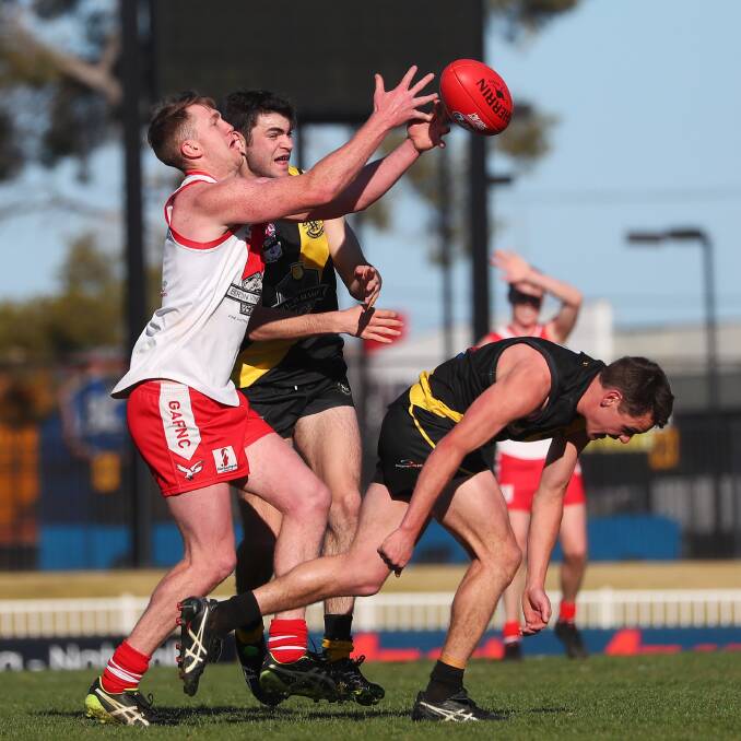 MATCH-WINNER: Griffith's Jacob Conlan tries to reel in a mark despite the best efforts of Wagga Tigers' Ben Kelly and Nick Ryan in the Riverina League game at Robertson Oval on Saturday. Picture: Emma Hillier
