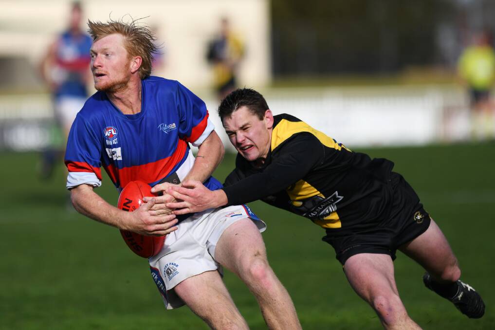 DESPERATION: Turvey Park co-coach Jeremy Sykes tries to escape Wagga Tigers captain Nick Ryan at Robertson Oval on Saturday.