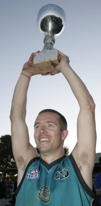 Matt Hard lifts the premiership cup aloft at Northern Jets in 2007.