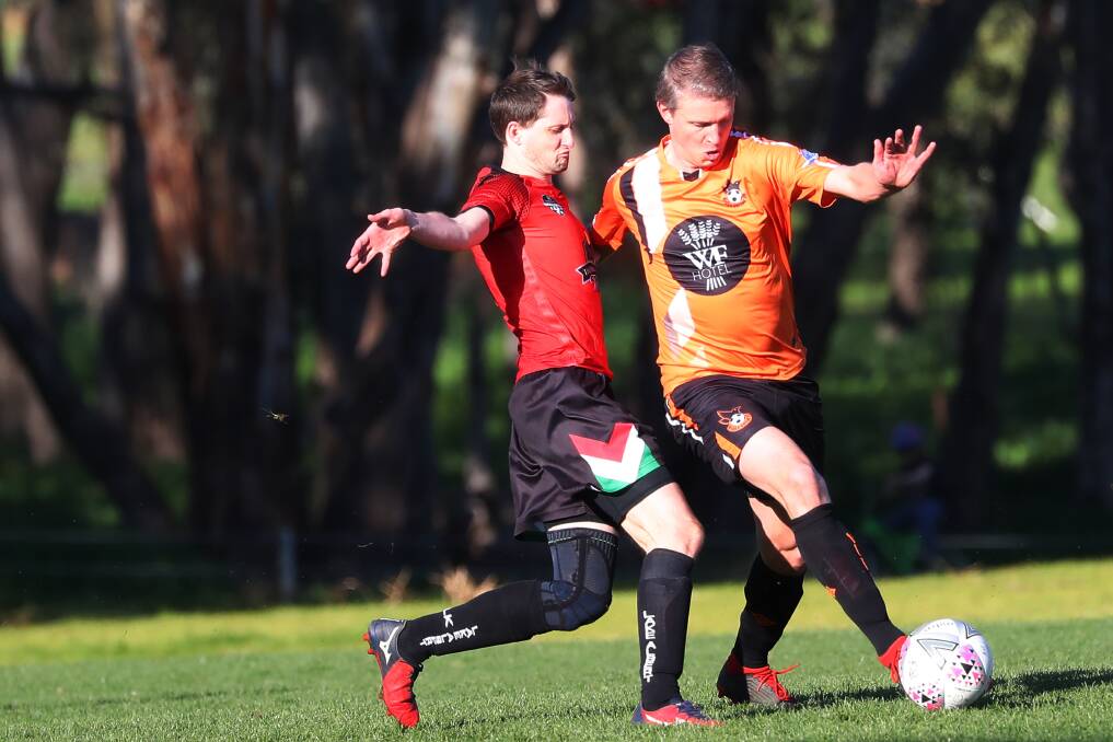 NOT FAR OFF: Lake Albert coach Mitch Tinnock challenges Wagga United's Adrian Merrigan in last Sunday's Pascoe Cup clash at Rawlings Park. Picture: Emma Hillier