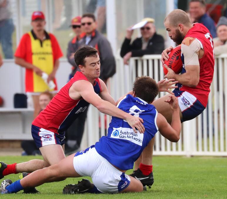 UNDER SCRUTINY: Wagga Tigers coach Shaun Campbell (right) takes a mark for Riverina League in the representative game against Farrer League at Robertson Oval last Saturday. Picture: Les Smith