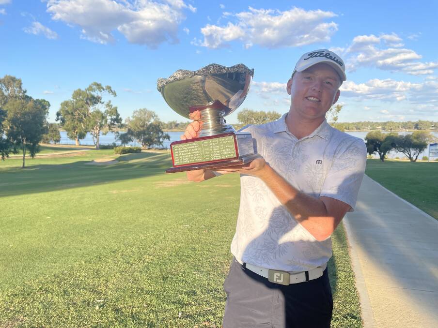 CHAMPION: Lucas Miller shows off the Wagga Pro-AM trophy
at Wagga Country Club on Friday. Picture: Matt Malone