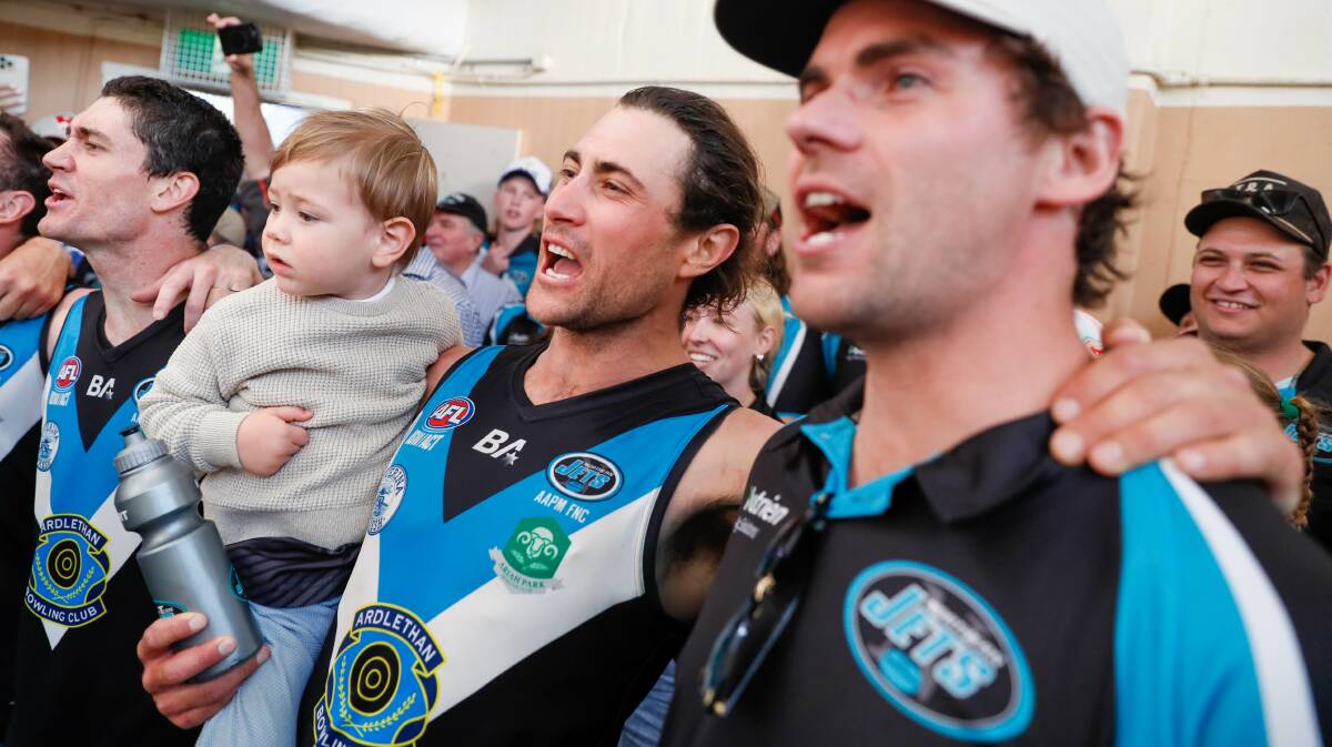 Injured Northern Jets forward Matt Wallis (right) sings the team song alongside Mitch Haddrill after Saturday's preliminary final win over Marrar. Picture by Les Smith