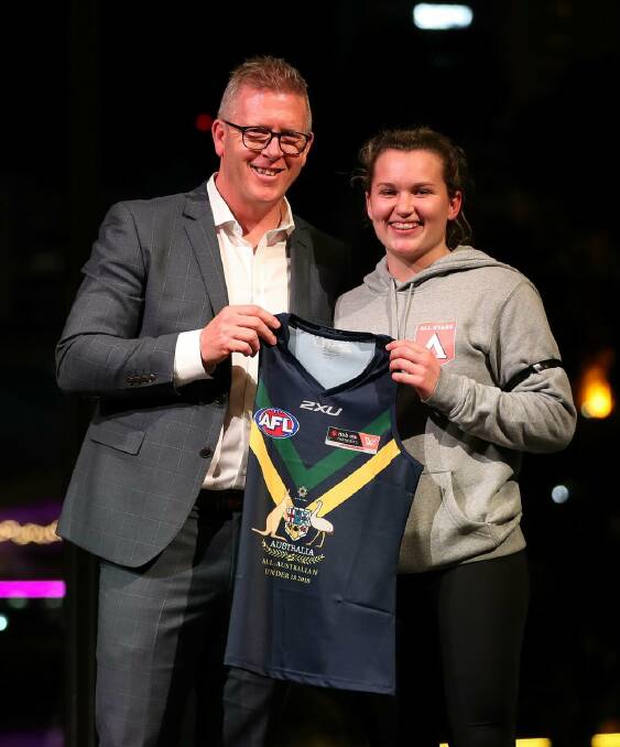 SPECIAL MOMENT: Alyce Parker is presented her All-Australian jumper from AFL head of football operations Steve Hocking.