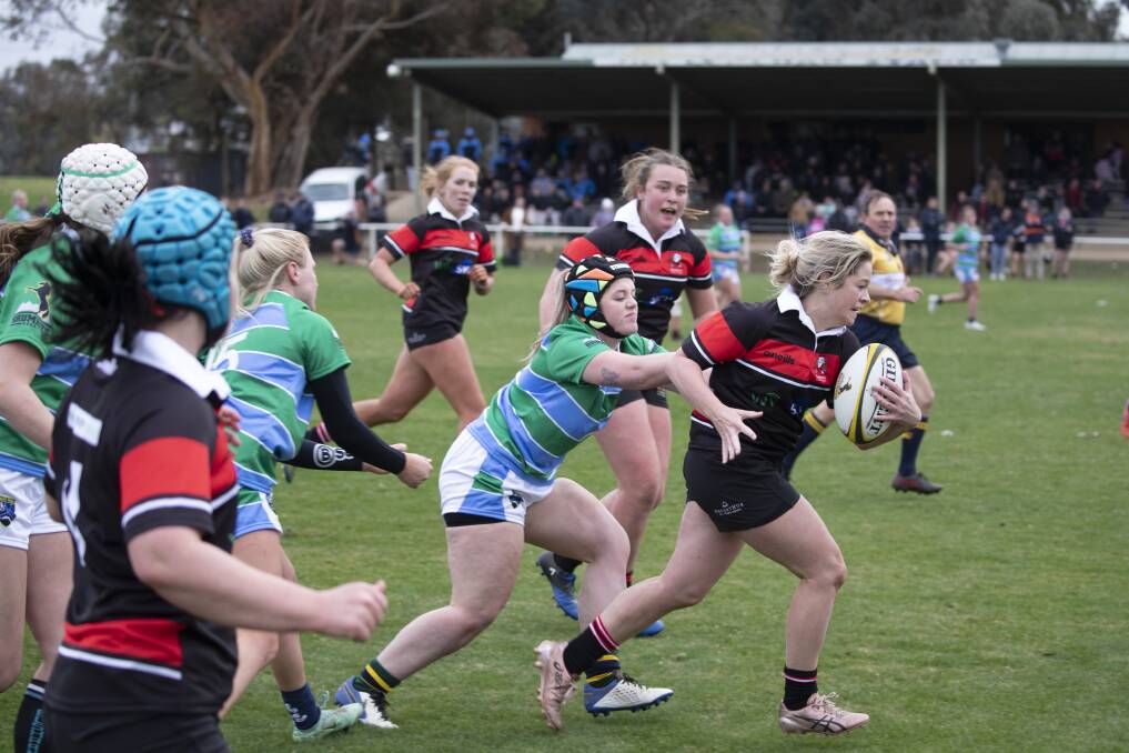 BREAK: Southern Inland Rugby Union fullback Megan Pearson looks to get away from South Coast-Monaro's Lauren Woodward at the Brumbies Provincial Championship at Conolly Rugby Complex on Saturday. Picture: Madeline Begley