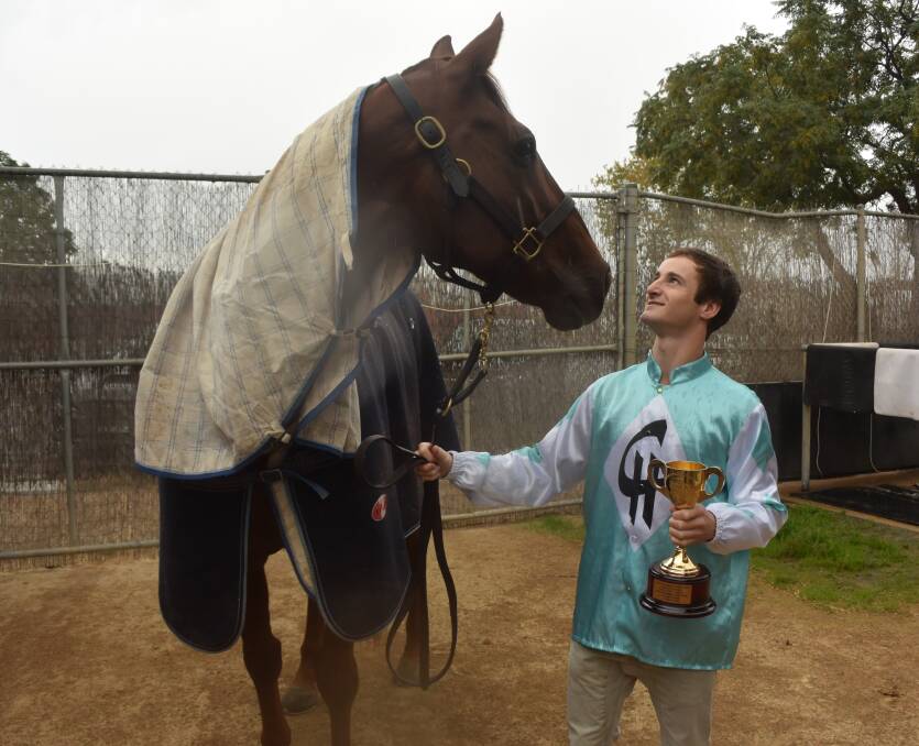 TOP TEAM: Wagga apprentice jockey Josh Richards spends some time with Class Clown at Chris Heywood's stables this week. Picture: Matt Malone