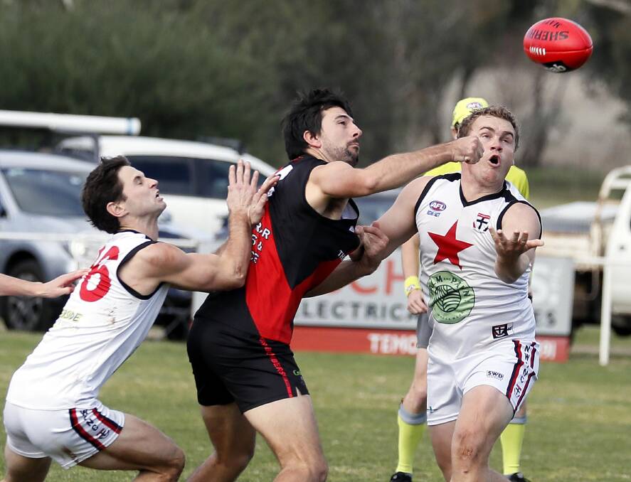 SPOIL: Marrar defender Cane Graetz looks to spoil North Wagga's Kirk Hamblin as Nathan Dennis also arrives late to the contest at Langtry Oval on Saturday. Picture: Les Smith