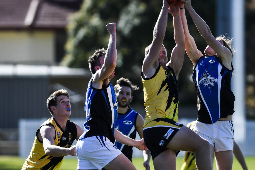 NEW SIGNING: Jordan Hedington (second from right) flies for Queanbeyan against Gungahlin in an AFL Canberra match last year. Picture: The Canberra Times