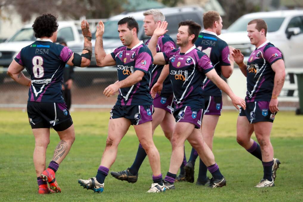 DECISION TIME: Southcity captain-coach Nathan Rose (second from left) celebrates a try with his Bulls teammates this season. Rose is yet to commit to a third season as coach. Picture: Les Smith
