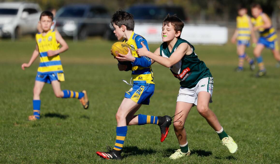 Mangoplah-Cookardinia United-Eastlakes' Thomas Treanor tries to shrug off the tackle of Coolamon's Bryce Robinson in an under 10 game at Mangoplah Sportsground last season. Picture by Les Smith