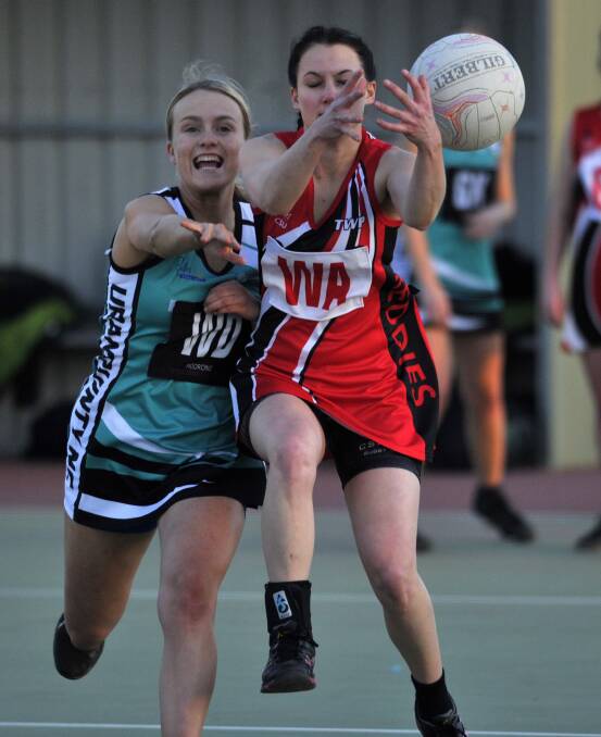 PRESSURE: Uranquinty's Rachael Grant stays in hot pursuit of CSU Reddies' Rachel Kirk in the A grade Wagga Netball game on Saturday. Picture: Chelsea Sutton