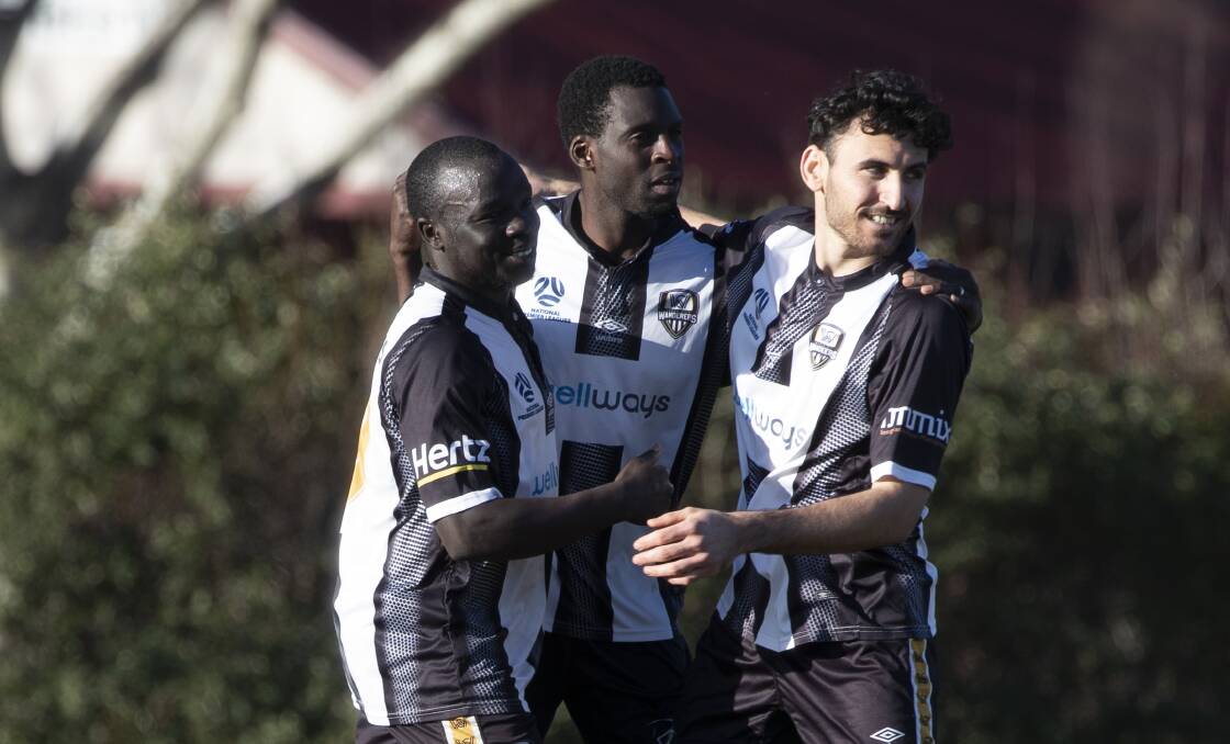 HAPPY DAYS: Jacob Ochieng (left) and Nashwan Sulaiman (right) celebrate Morris Kadzola's successful penalty at Gissing Oval on Saturday. Picture: Madeline Begley