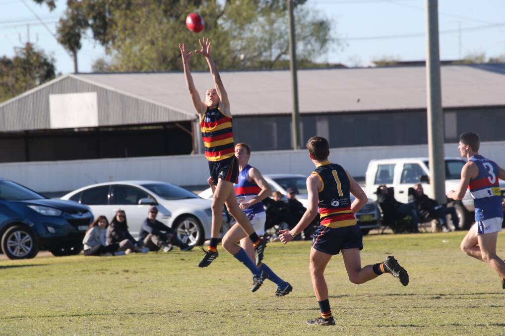 LEAP: Cooper Sharman flies into the air to mark for Leeton-Whitton against Turvey Park at Leeton Showground on Saturday. Picture: Anthony Stipo
