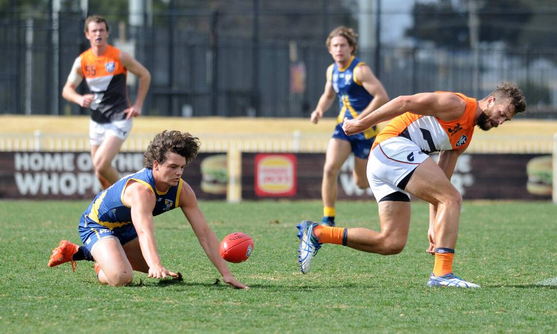 HEADED HOME: Jacob Turner in action for Canberra Demons against Greater Western Sydney's Tim Mohr in the NEAFL game at Wagga's Robertson Oval in 2017.