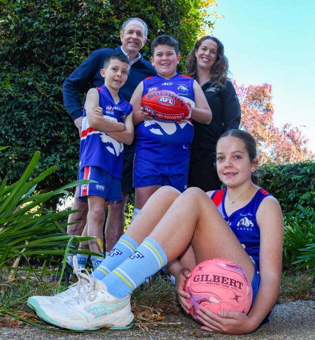 Terry and Bec Daniher show off the new Big Freeze socks to Turvey Park juniors Billy, Judd and Mia McKelvie. Picture by Bernard Humphreys