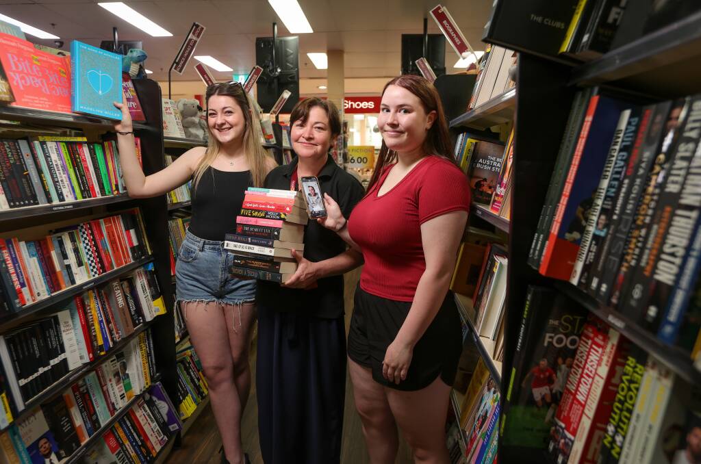 QBD Books Albury (Lavington Square) team leader Jacquie Galvin with Billabong High School Year 12 students Allanah Bakes and Madison Disley, both 17, who are hooked on BookTok. Picture by James Wiltshire