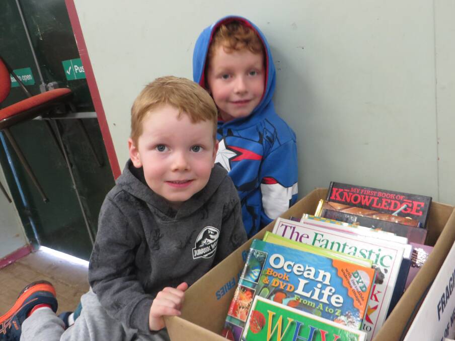 There will be something for all ages at the Book Fair, with avid young readers like these able to find readable treasures among the rows of boxes. Picture supplied.