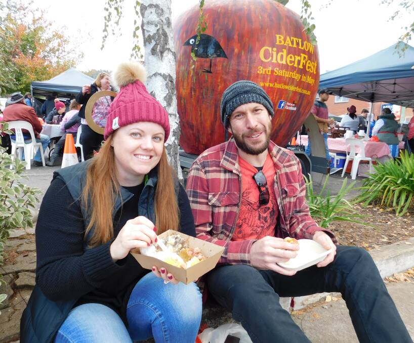 RUGGED UP: Alera Shipard and Sam Shipard from Wagga enjoy last year's Cider Fest street party.
