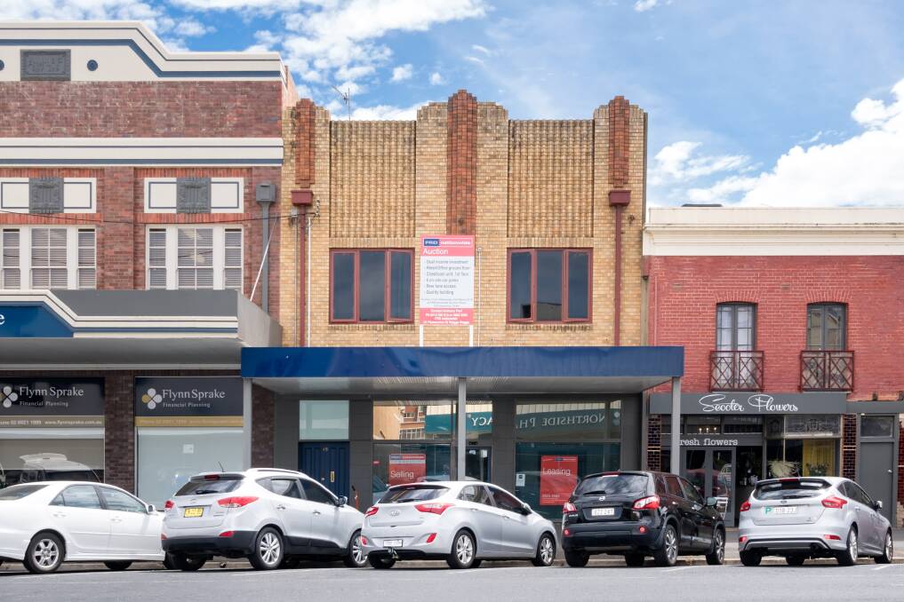 13 Gurwood Street: A two-storey brick building with the ground floor being used for commercial purposes and a first floor residential unit.