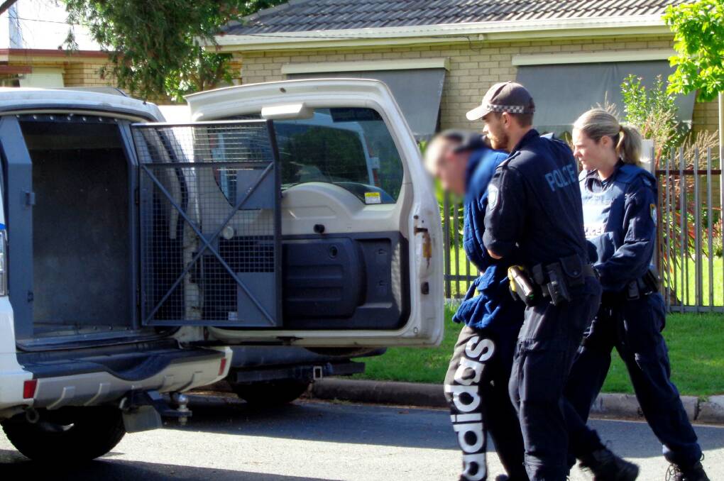 ARREST: Police take a Bandidos member into custody on Wednesday. Pictures: NSW POLICE