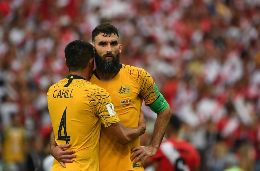 DISAPPOINTMENT: Tim Cahill and Mile Jedinak after the Socceroos' loss to Peru.