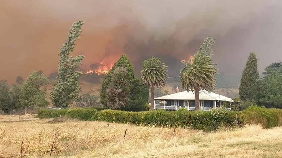 AFTERMATH: The Dunns Road fire looms over a property outside Tumbarumba at the end of December 2019. Picture: FILE