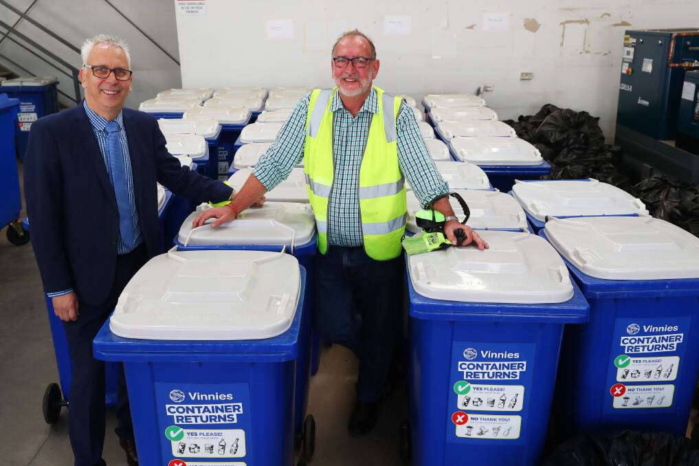 HOW YOU BIN: Mike Riley and Peter Quarmby survey the bins filled with 30,000 containers to be processed at the Wagga facility. Picture: Emma Hillier